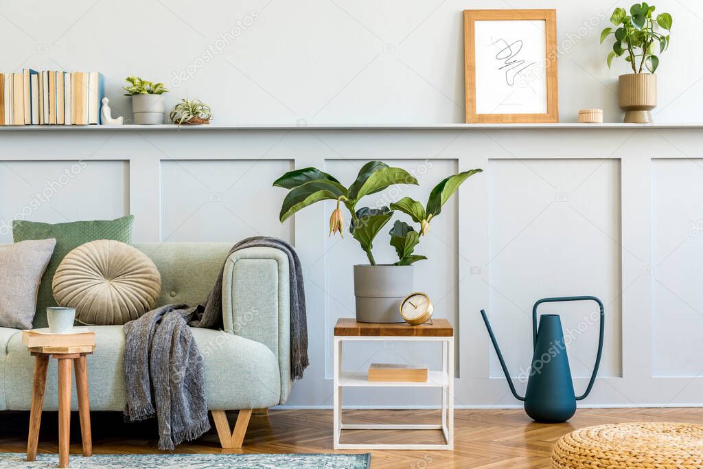 Minimalistic composition of living room with design sofa, coffe table, plant, books, decoration, pillows, plaid, carpet, wood paneling and elegant persoanl accessories in stylish home decor.