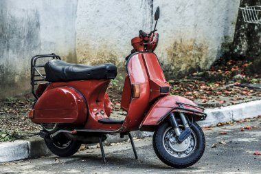 red scooter on street clipart