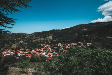 Orange roofs. Panoramic view near of Kato Lefkara - is the most famous village in the Troodos Mountains. Limassol district, Cyprus, Mediterranean Sea. Mountain landscape and sunny day. clipart