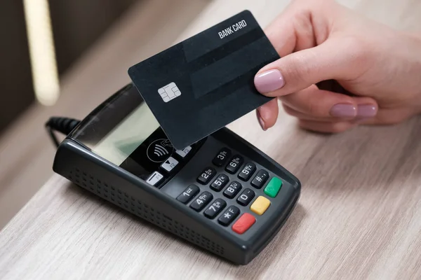 Customer using credit card for payment to owner at cafe restaurant, cashless technology and credit card payment concept