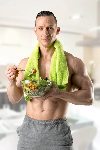 Healthy man eating a salad