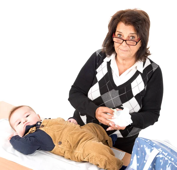 Grandmother changing baby diaper — Stock Photo, Image