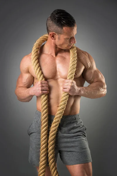 Powerful man with a rope — Stock Photo, Image