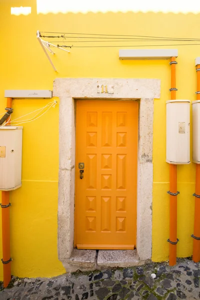 Orange door in Mouraria old district, in Lisbon. Portugal