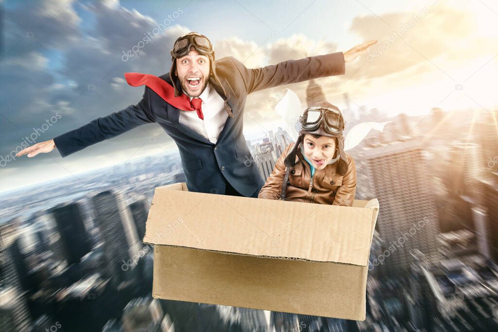 Man and kid flying in a carboard box over the city