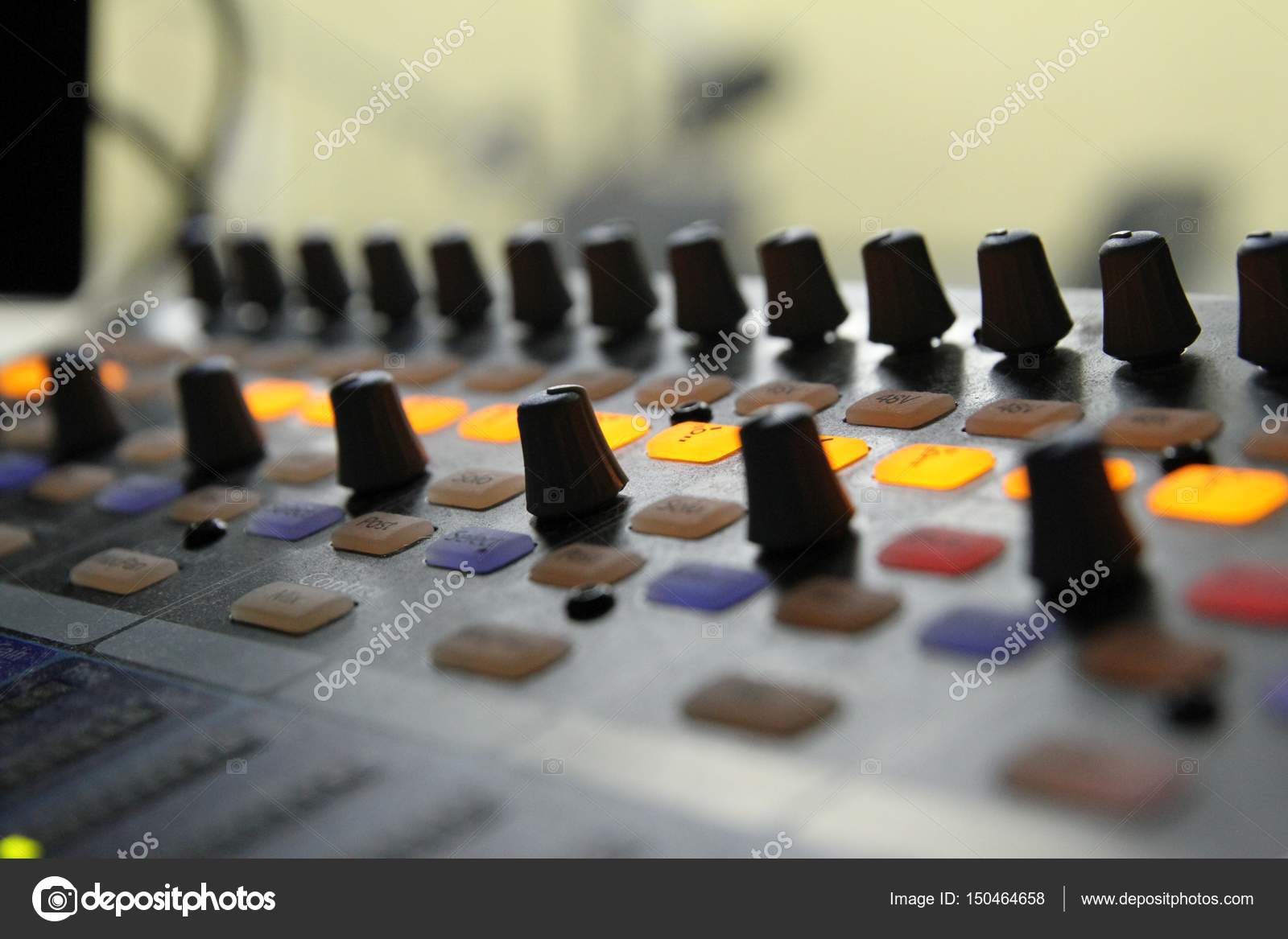 Professional audio operator working on audio mixer knobs during live TV