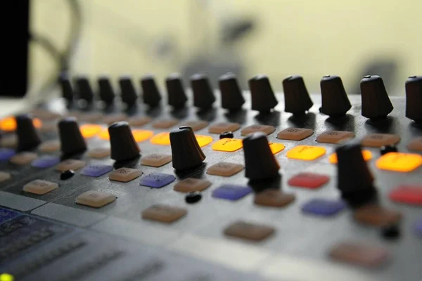 Professional audio operator working on audio mixer knobs during live TV telecast — Stock Photo, Image