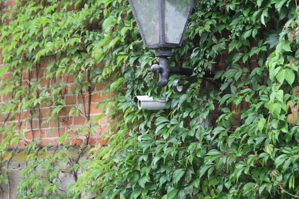 Rotating surveillance camera on brick wall