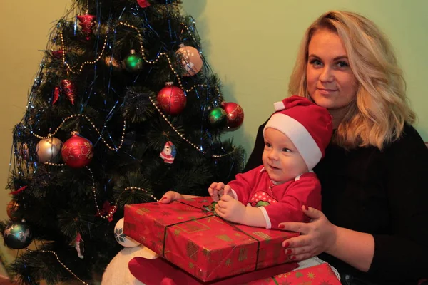 Feliz bebê pequeno bonito no traje do Papai Noel perto de decoração de árvore de Natal — Fotografia de Stock