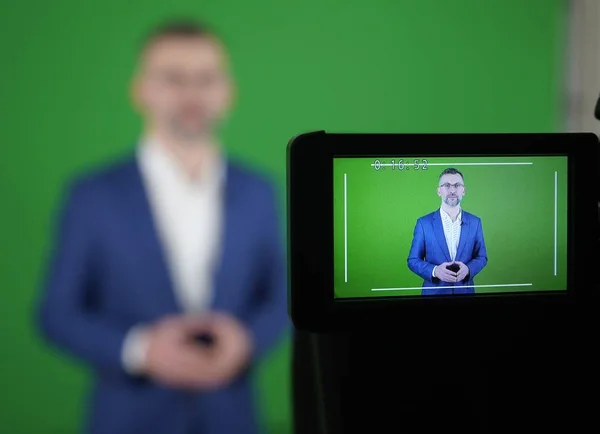 Un bloguero está grabando un video sobre un fondo verde. El camco — Foto de Stock