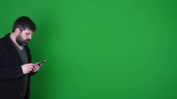 Bearded Man Photographs Smartphone Green Background Bearded Man Shoots Video — Stock Video