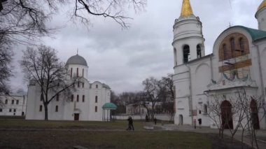 Chernihiv, Ukraine - February 2020: View of the domes of the church. City view, people walk around the city against the background of the church.