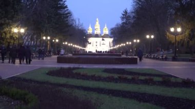 Chernihiv, Ukraine - February 2020: View of the domes of the church. City view, people walk around the city against the background of the church.