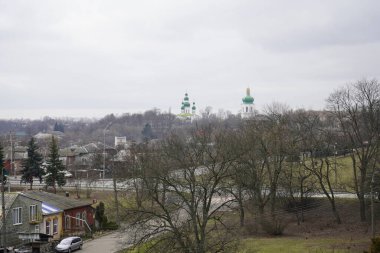 Chernihiv, Ukraine - February 2020: View of the domes of the church. City view, people walk around the city against the background of the church.