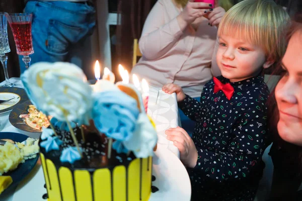 ４歳の少年はケーキの中でろうそくを消した 4歳の子供の誕生日 ケーキナンバー4 息子の誕生の家族の祭典 — ストック写真