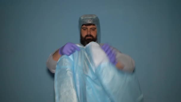 Bearded Doctor Puts Protective Medical Suit Laboratory Covid Coronavirus Pandemic — Stock Video