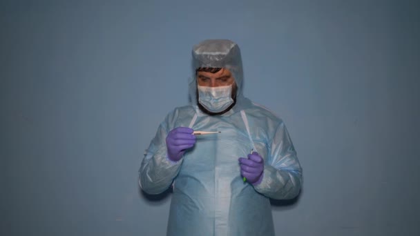 Bearded Doctor Puts Protective Medical Suit Laboratory Covid Coronavirus Pandemic — Stock Video