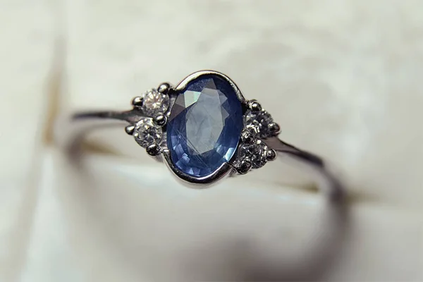 Close-up of white gold ring with precious stones — Stock Photo, Image