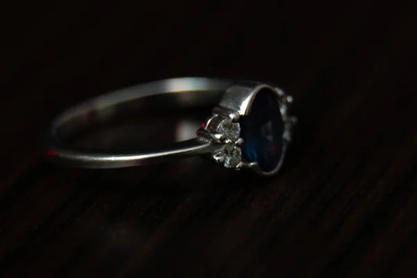 Close-up of white gold ring with precious stones — Stock Photo, Image