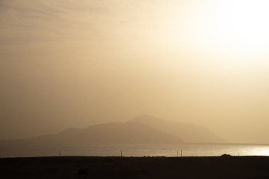Aralık 'ta gün batımında Kızıl Deniz' in arka planına karşı Sharm El Sheikh dağı