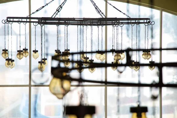 Old vintage chandelier hanging on the ceiling of a hotel in egypt — Stock Photo, Image