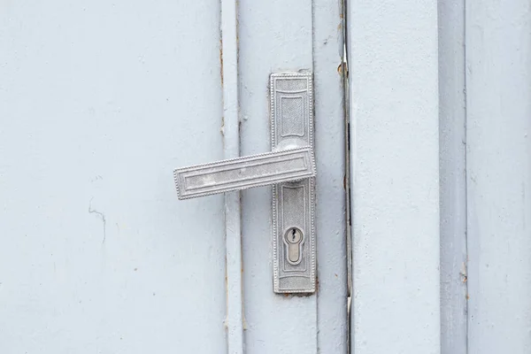 old door handle on an iron fence