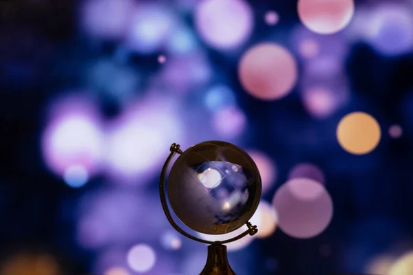 clear glass globe with blurred background on the table