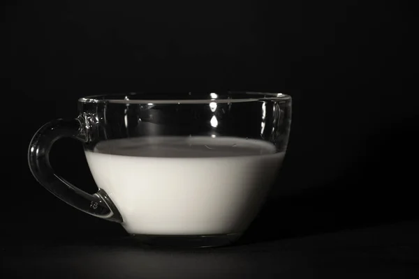 Glass with milk on a dark isolated background — 스톡 사진