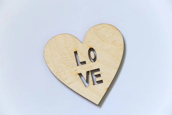 Heart made of wood with the inscription love on a white background, feelings and emotions — 스톡 사진