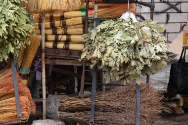 brooms on a window at a bazaar in the city of Dnipro