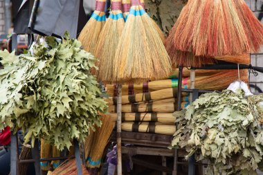 brooms on a window at a bazaar in the city of Dnipro