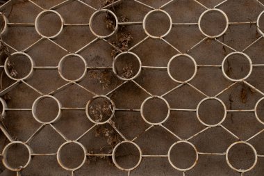 old rusty lattice on a window of a house