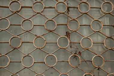 old rusty lattice on a window of a house