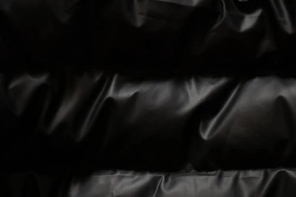 Background of a black puffer jacket close up — Stock Photo, Image