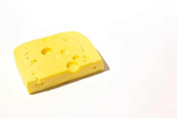 Piece of cheese on a white isolated background — 스톡 사진