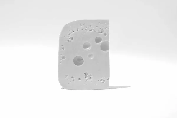 Trozo de queso sobre un fondo blanco aislado —  Fotos de Stock