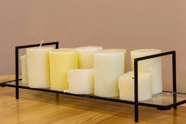 Candles stand on coasters on the table — 스톡 사진