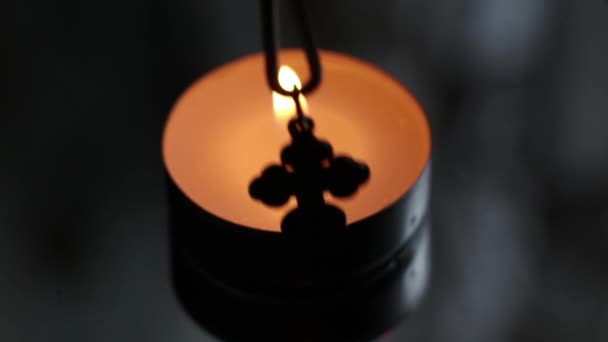 Candle Flame Dark Room Silver Christian Cross — Stock Video