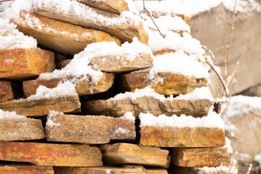 decorative stone in the snow on the street in winter