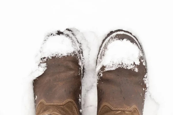 Botas de mujer en la vista superior de la nieve —  Fotos de Stock