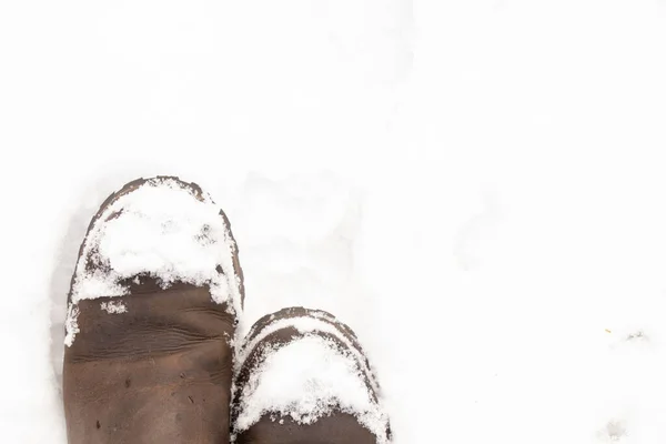Women's boots in the snow top view — 图库照片