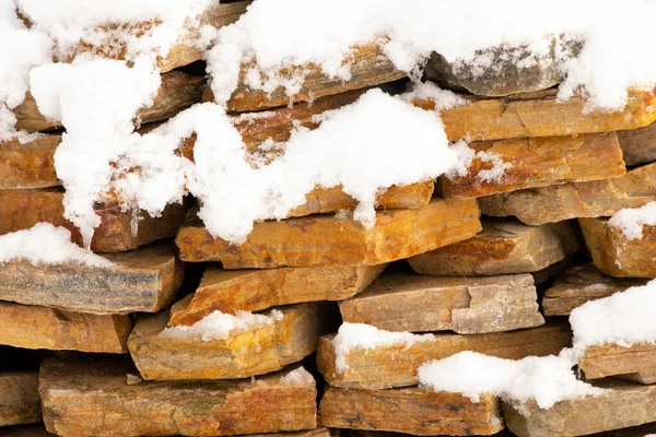 Decorative stone in the snow on the street in winter — Stok fotoğraf