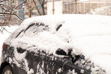 car on the road in Ukraine in the city of Dnipro in the snow on the street in winter