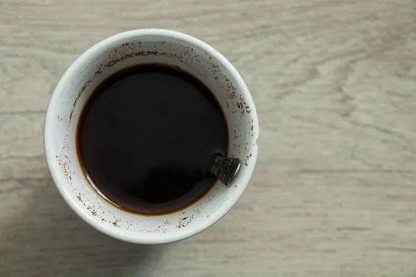 Cup with coffee stands on a wooden table — ストック写真