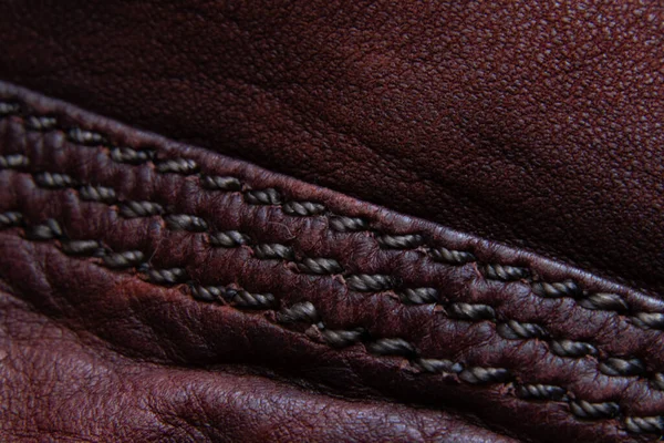 Background of red skin and seam closeup — Stockfoto