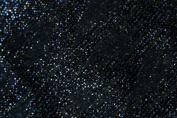 Black shiny plain fabric close-up — 图库照片