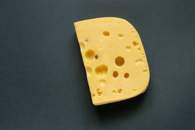 piece of cheese on a gray background clipart