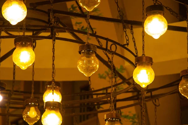 Chandelier on the wall in a dark room indoors — Stock Photo, Image