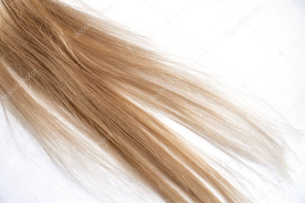 blond long hair on a white background close-up