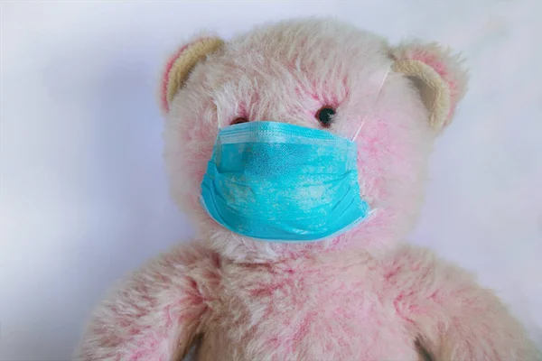 baby teddy bear masked medical closeup epidemic